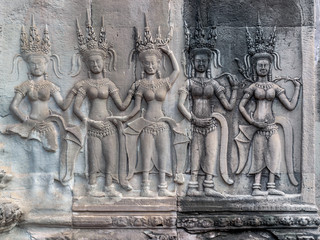 Stone carving of angels or Apsara on the wall of Angkor Wat, the 12th century Hindu temple complex in Cambodia