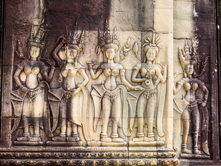 Stone carving of angels or Apsara on the wall of Angkor Wat, the 12th century Hindu temple complex...