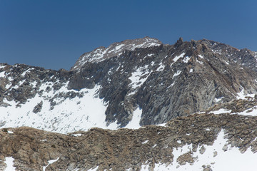 Snow covered granite peaks and cliffs during Spring in California's Sierra Nevada mountains