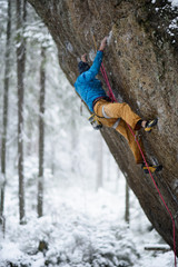 Rock climber ascending a challenging cliff. Extreme sport climbing. Freedom, risk, challenge, success. 