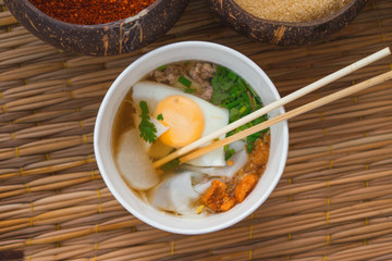 Cup of a Noodle Soup with Egg, spices on background