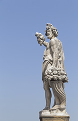 Fototapeta na wymiar Statue at Ponte Santa Trinita in Florence, Italy