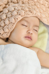 Baby sleeping on bed in the bedroom