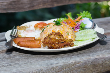 American fried rice on plate on wood table
