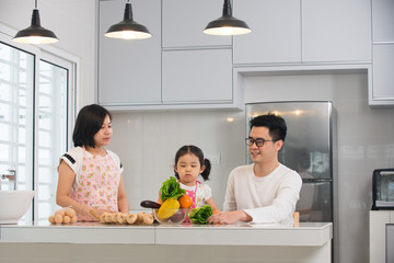 asian family cooking at kitchen