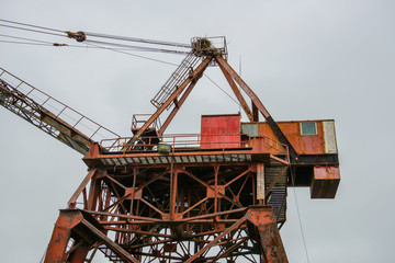 Fototapeta na wymiar World war II era rusty crane with Osprey nest on top 