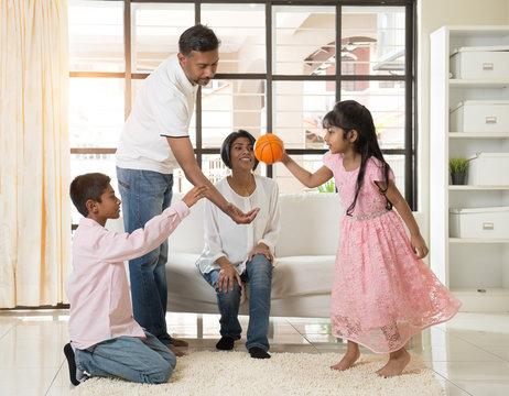 Indian Family Playing With Ball In Living Room