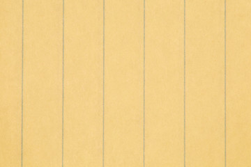 close up ruled yellow paper texture as a backgrounb