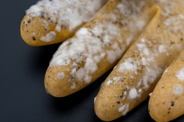 yellow moldy glove on a black background