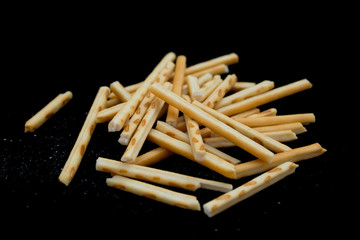 side view pretzel sticks on a black background