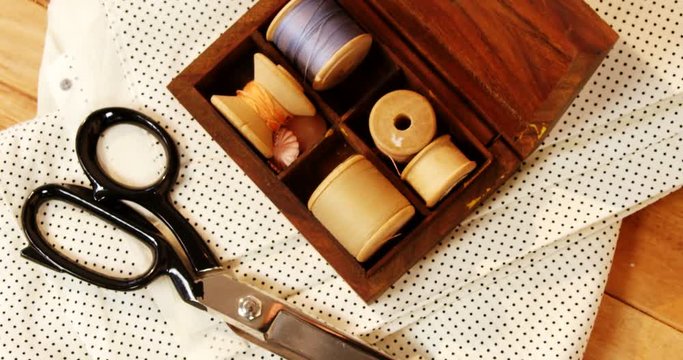 Close-up Of Thread Roll In A Box And Scissor On A Table 4k