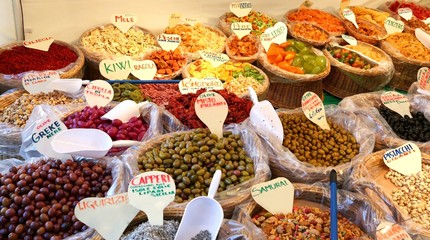 baskets of dried fruit for sale at the fruit market in italy