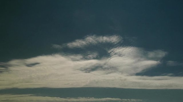 Wavy Clouds Drift Through Sky