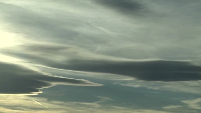Wavy Jet Contrails and Mountain Wave Clouds