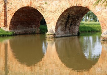 old bridge made of red brick with arches