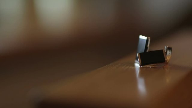 Black cufflinks on the table.