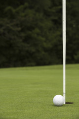 Obraz premium Golf ball close to pin and hole