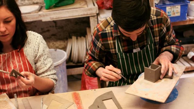 Potters working in pottery shop