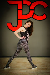 Brunette street dancer girl wearing casual clothes background gr