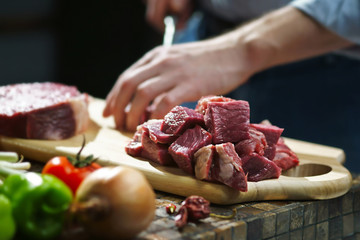 Man cuts the meat with a knife