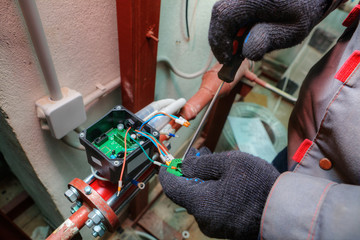 Mechanic engineer installs equipment for central heating systems