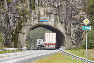 Tableaux ronds sur plexiglas Tunnel Norwegian rocky mountain road tunnel with heavy trucks