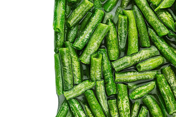 Border of wet fresh green french bean in water  closeup on white background. Isolated. Healthy vitamin food.