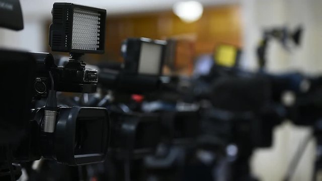 Lots of television cameras in a row broadcasting a live event