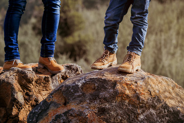mother and son hiking boots in mountains