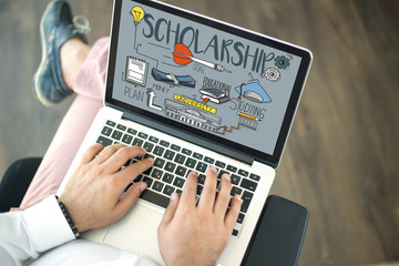 People using laptop and SCHOLARSHIP concept on screen