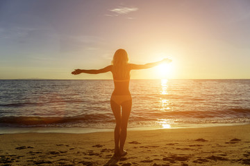 Fototapeta na wymiar Happy Carefree Woman on the Beach