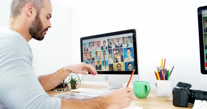 Female graphic designer working on computer at office 4k