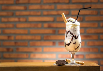 Homemade milkshake (chocolate smoothie) with cookies on rustic w