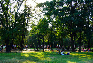 People are jogging and cycling in the public park in the early morning at Wachirabenchathat Park or State Railway Public Park is a name of public park in Chatuchak district, Bangkok, Thailand.