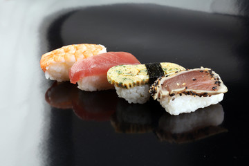 close up of sashimi sushi set with chopsticks and soy - sushi roll with salmon and sushi roll with smoked eel, selective focus.