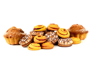 Cake, chocolate chip cookies and biscuits with jam round shape closeup on a white background.