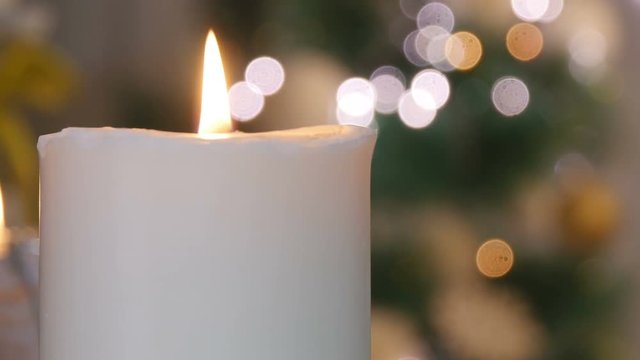 Christmas candles and ornaments on a dark background with lights