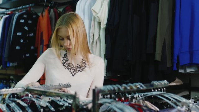 Young woman chooses underwear in a clothing store