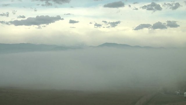 Breaking Waves of Fog Crash over Hillsides in Time Lapse