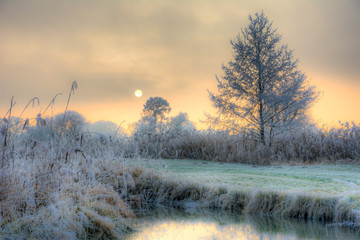 Sunset on a foggy winter day at the river Paar
