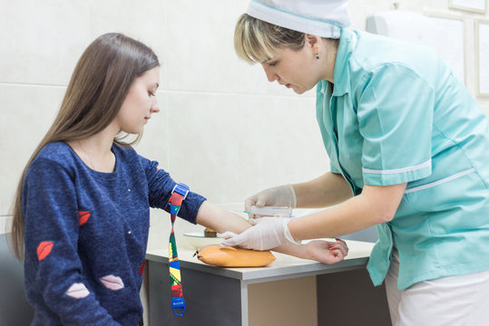 nurse takes a blood sample from the patient