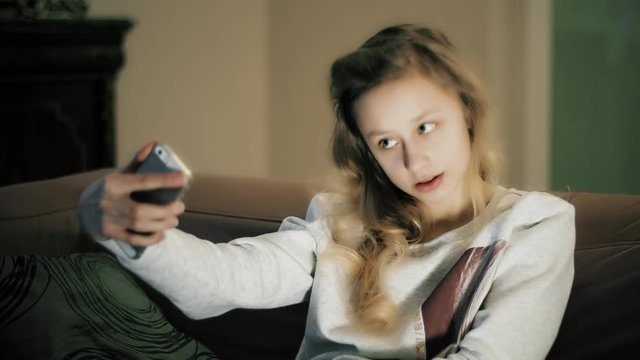 Happy teenager girl take selfie portrait using smartphone app