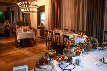 wedding tables in the restaurant are decorated with rustic wooden stumps
