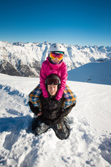 Fototapeta na wymiar Happy couple of snowboarders in the alpine mountains