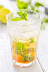 Mojito Cocktail isolated on a White Wooden Background, Vertical View