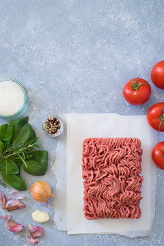Ingredients for bolognese sauce: ground meat, tomato, onion, garlic, herbs, seasonings
