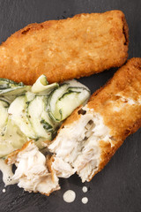 breaded cod and fresh cucumber salad on slate