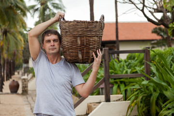 Man  holding a straw empty basket