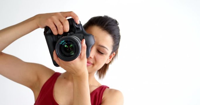 Photographer taking photo with professional digital camera in studio 4k