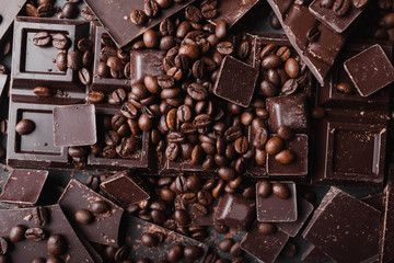 Broken slices of chocolate and coffee beans. Chocolate chocolate chunks. Chocolate bar pieces.  A large bar of chocolate . Background with chocolate